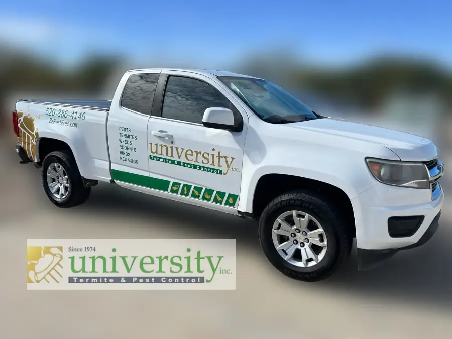 White pest control truck with "University Termite & Pest Control" logo and contact details parked on a blurred background.